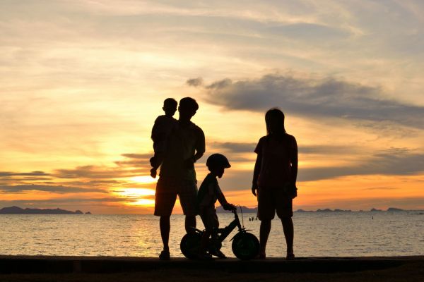 Silhouette image of a family by water | W8 Advisory | Family wealth management for African families